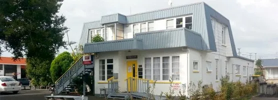 The practice at 17 East Street: a white two-storey building with a grey roof, a yellow front door and yellow stair rails